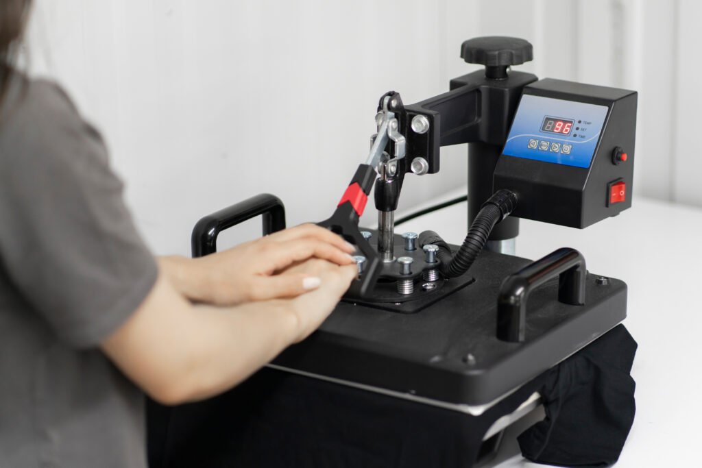 girl makes new craft t-shirt with textile print using press printer machine